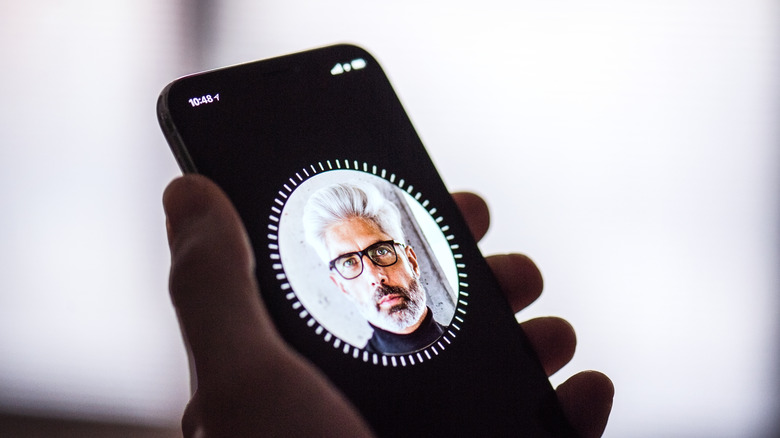 The iPhone setup screen showing the Face ID configuration process.