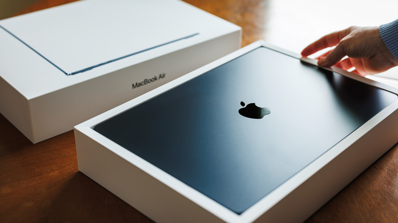 An unboxed 15-inch MacBook Air showing its slim profile and premium packaging.