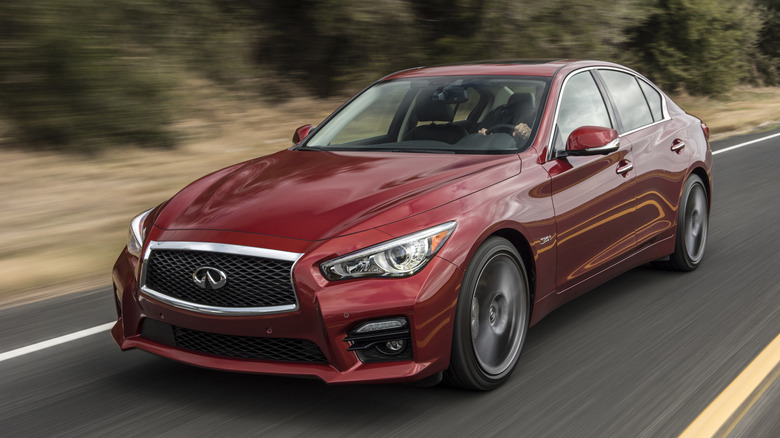 A 2016 Infiniti Q50 Red Sport 400 in motion on an open road.