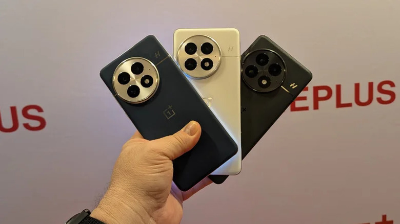 Multiple OnePlus smartphones arranged to show different color options and back finishes.
