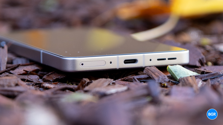 The bottom frame of the OnePlus 13R highlighting the USB-C charging port.
