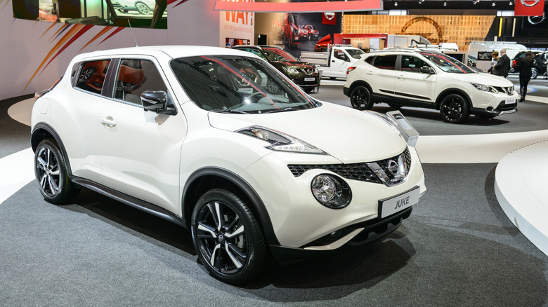 A white first-generation Nissan Juke on display at an auto show.