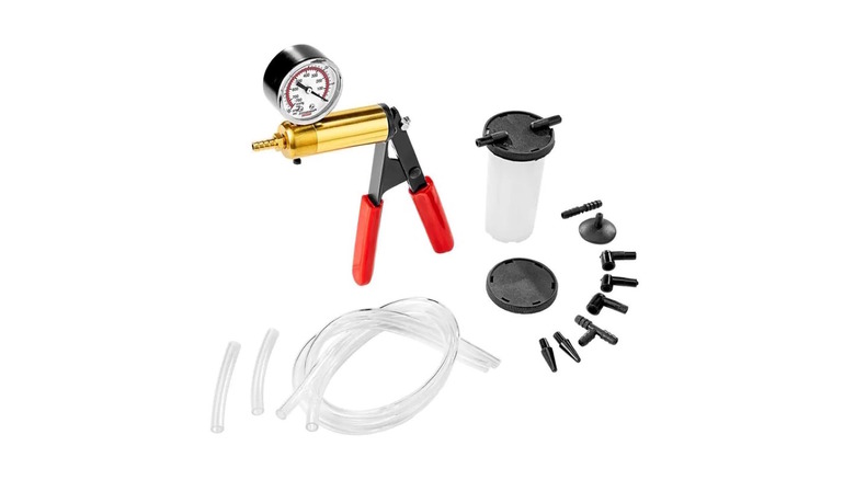 A hand-operated vacuum pump kit for bleeding brakes with multiple plastic adapters.