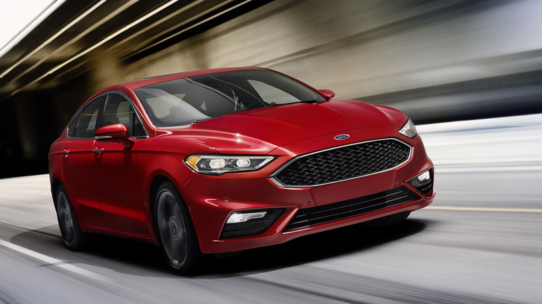 A 2017 Ford Fusion Sport driving through a brightly lit tunnel.