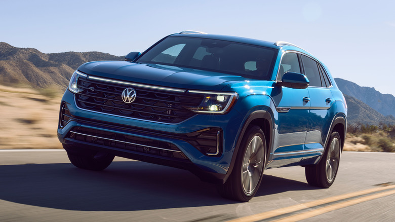 A Volkswagen Atlas Cross Sport positioned in a dramatic desert landscape.