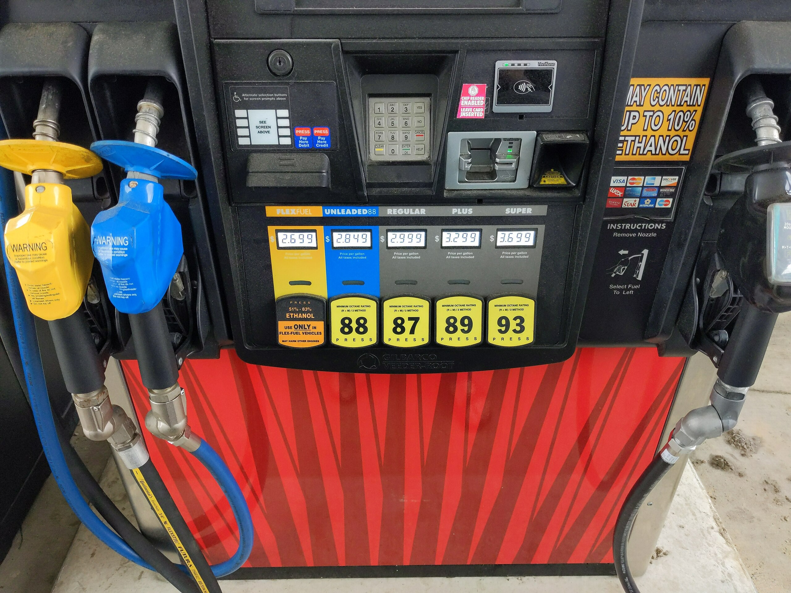 A side-by-side comparison of a clear fuel sample and a phase-separated gasoline sample in mason jars.