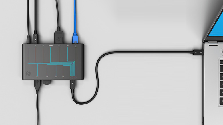 A high-end Thunderbolt docking station connected to a laptop.