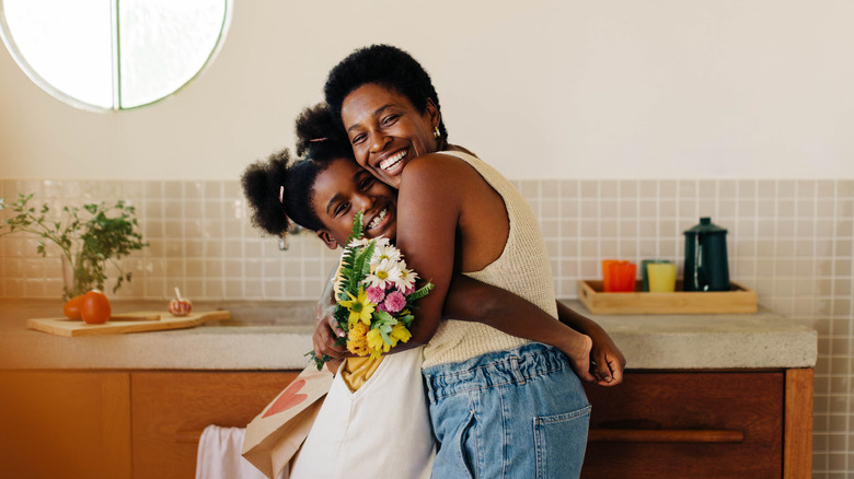 A heartwarming photo of a mother and daughter sharing a hug.