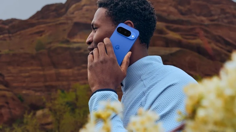 A person holding and interacting with a Google Pixel 10 smartphone.