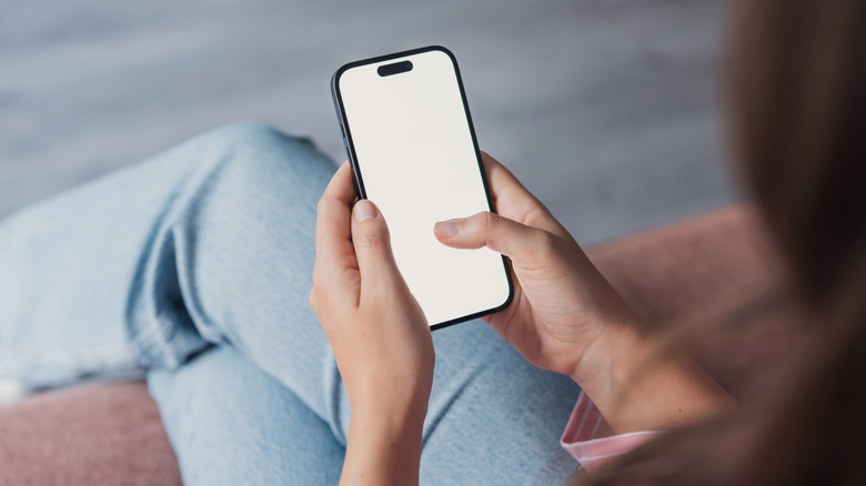 A person navigating through the sound and haptics options on a mobile device.